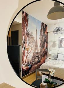 a mirror in a bedroom with a mural of the eiffel tower at Deck&Dwell in Trece Martires +9 photos