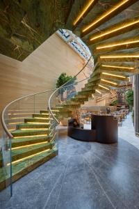 a spiral staircase in a building with tables and chairs at Mandarin Oriental Mayfair, London in London