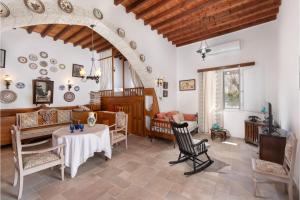 a living room with a table and chairs at Traditional Dream House in Soroni
