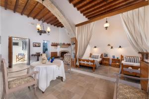 a living room with a table and chairs and a fireplace at Traditional Dream House in Soroni +7 photos