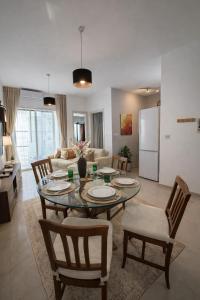 a kitchen and a living room with a table and chairs at Twin Apartment in St. Julianʼs +3 photos