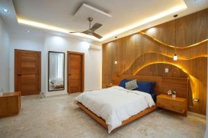 a bedroom with a large bed with a wooden wall at Modern Villa with a 15m Lap Pool, Cabarete in Cabarete +26 photos