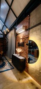 a brick wall with a table in a room at Sekinchan Tiny House - Moslim Only in Sekinchan