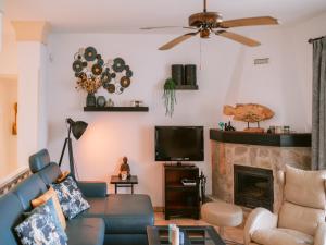 a living room with a blue couch and a fireplace at Villa in Cala Llonga near Beach & Ferry Port in Cala Llonga +30 photos