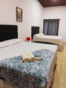 two beds in a room with towels on them at Hotel Ejecutivo VIP, La Paz in La Paz