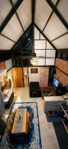 a living room with a table and a couch at Sekinchan Tiny House - Moslim Only in Sekinchan
