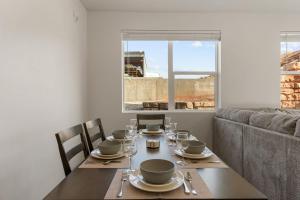 a dining room table with chairs and a couch at Ohana Nest condo in Hurricane