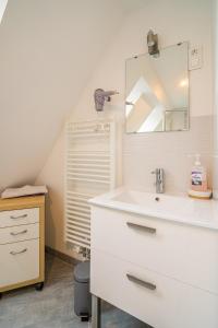 a bathroom with a sink and a mirror at Au nid d'Alsace - SPA et sauna privé in Orschwiller +6 photos