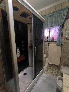 a bathroom with a shower with a glass door at GamaBarros1-Charneca in Charneca
