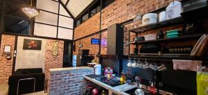 a kitchen with a counter and a brick wall at Sekinchan Tiny House - Moslim Only in Sekinchan