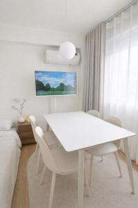 a white dining room with a white table and chairs at 온스테이 송파 On Stay Songpa in Seoul