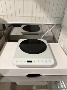 a stove top oven sitting in a refrigerator at 온스테이 송파 On Stay Songpa in Seoul