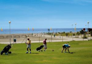 a group of people playing in a park near the beach at Playa Granada Mar de Fabiola in Motril