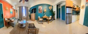 a living room with orange and blue walls at Casa Lio, Caribbean Pool Residence in Boca Chica