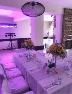 a dining room with a table with purple lighting at Einstein House & Spa in Marchevo +75 photos