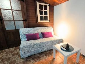 a living room with a couch and a table at Villa Tamadaba Rural Home - Pet Friendly, Near Ocean, Ideal for Long Stays in Agaete