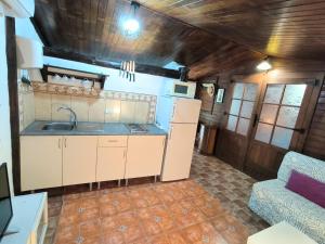 a kitchen with a sink and a couch in a room at Villa Tamadaba Rural Home - Pet Friendly, Near Ocean, Ideal for Long Stays in Agaete