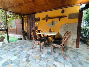 a patio with a table and chairs on a stone floor at Villa Tamadaba Rural Home - Pet Friendly, Near Ocean, Ideal for Long Stays in Agaete