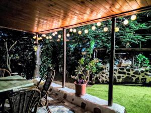 a patio with a table and chairs under a wooden ceiling at Villa Tamadaba Rural Home - Pet Friendly, Near Ocean, Ideal for Long Stays in Agaete +8 photos