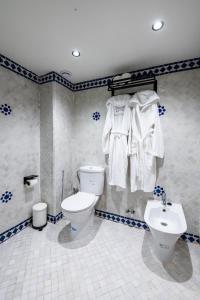 a blue and white bathroom with a toilet and a sink at Riad Jasmine in Rabat