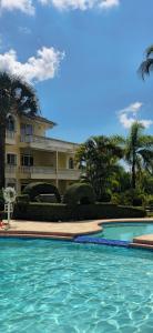 a large swimming pool in front of a building at Casa Lio, Caribbean Pool Residence in Boca Chica