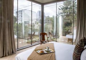 a hotel room with a bed and a large window at Casa JuliAna in Mexico City