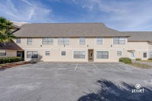 a large house with a parking lot in front of it at Nautical Costa Del Mar on Holiday Isle in Destin