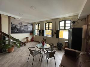 a living room with a table and chairs at Pousada Bahia Morena in Salvador