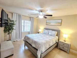 a bedroom with a bed and a ceiling fan at Nautical Costa Del Mar on Holiday Isle in Destin