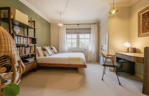 a bedroom with a bed and a desk and a window at Kyuquot House in Woodbridge