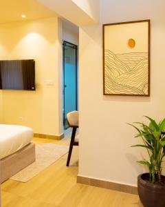 a bedroom with a bed and a plant at 7EVEN Suites in Lagos
