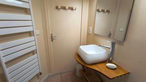 a bathroom with a sink and a mirror at Le Repaire du Loup blanc in Prémanon +44 photos