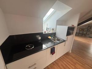 a kitchen with a sink and a counter top at Bright attic apartment with charm in Sargans