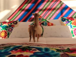a toy llama standing on top of a couch at TiticacaIntiLodge in Puno