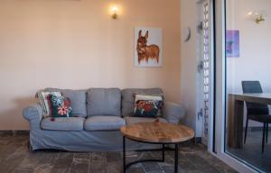 a living room with a blue couch and a table at Watervillas Breezy Bay in Kralendijk