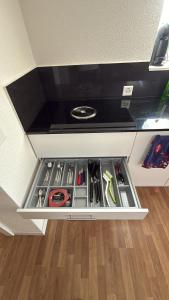 a drawer in a counter withtools in it at Bright attic apartment with charm in Sargans