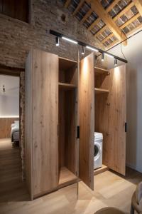 a large wooden closet in a room at Mon Suites San Pedro in Valencia +73 photos
