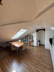 a room with a table and chairs in a attic at Bright attic apartment with charm in Sargans