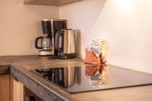 a kitchen with a counter top with a coffee maker at Watervillas Breezy Bay in Kralendijk