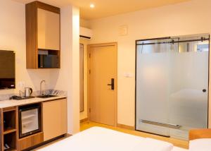 a kitchen with a glass shower in a room at 7EVEN Suites in Lagos +17 photos