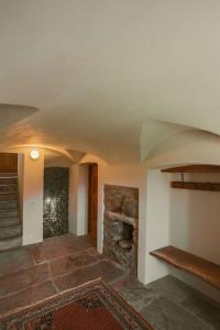 a room with a stone fireplace in a house at Appartamento LA ROSA in Ponto Valentino