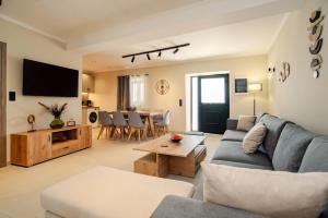 a living room with a couch and a table at Villa Kalimoukos in Corfu