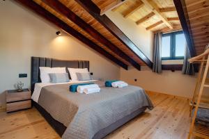a bedroom with a large bed with two towels on it at Villa Kalimoukos in Corfu +46 photos