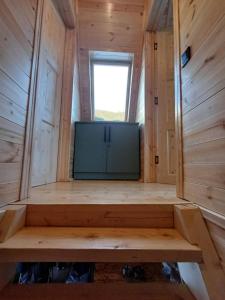 a large screen tv in a tiny house at Mestia Inn Chalet in Mestia