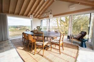 a dining room with a table and chairs at The Barn at Manor Farm in Great Glemham