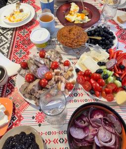 a table with many plates of food on it at La Măgaru Tăvălit in Nucşoara +39 photos