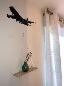 a model of a plane is hanging on a wall at Aéroport à pied, Escale 25 in Tillé +23 photos
