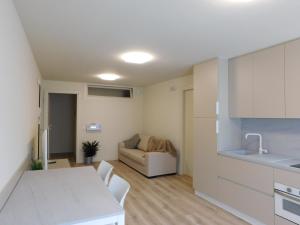 a kitchen and living room with a table and a couch at Corte Trambai in Gambellara