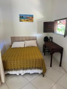 a bedroom with a bed and a table in it at Pousada da Lucinha in Canoa Quebrada +38 photos