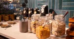 a counter with four jars of granola on it at PLAZA INN Ulm in Ulm